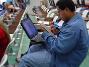 Image of student working at a computer in a classroom