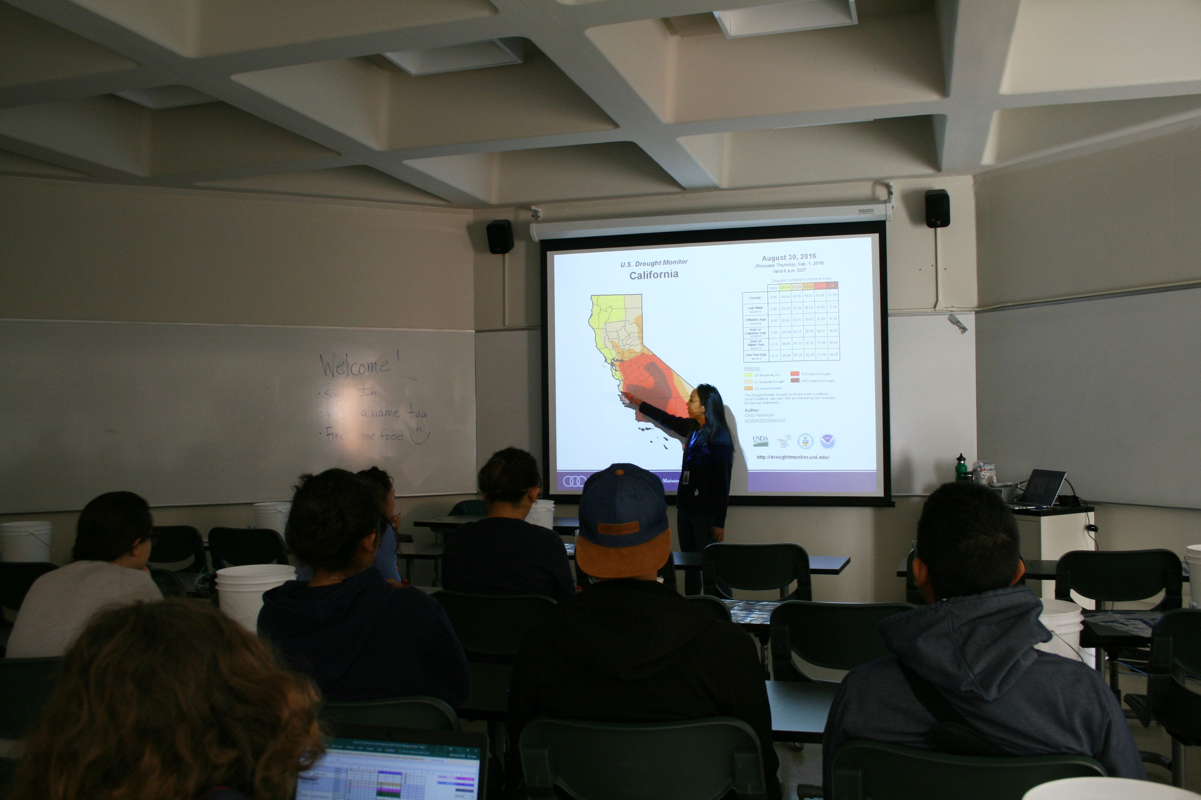 Presenter pointing at a heat map of california