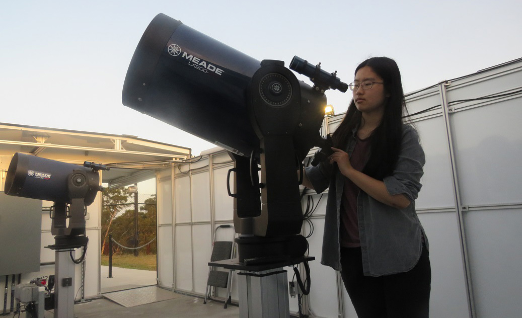 Canada student adjusting a telescope at our observatory.