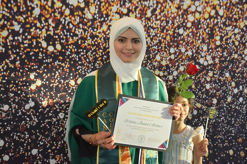 latinx.graduation.student.with.flower