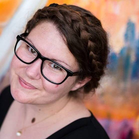 Woman with braided hair, smiling at the camera.