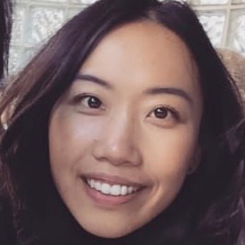 Asian American woman with dark straight hair, smiling at the camera.