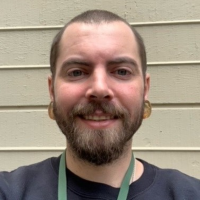 Chris' Picture White man with a beard smiling at the camera.