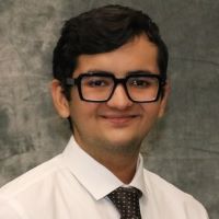 young man with glasses in shirt and tie