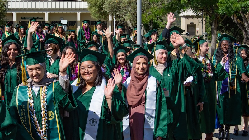 Graduates waving