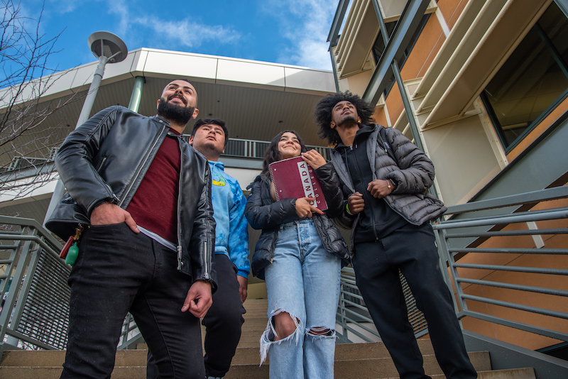 Group of students gazing into the distance, their attention drawn away from the camera.