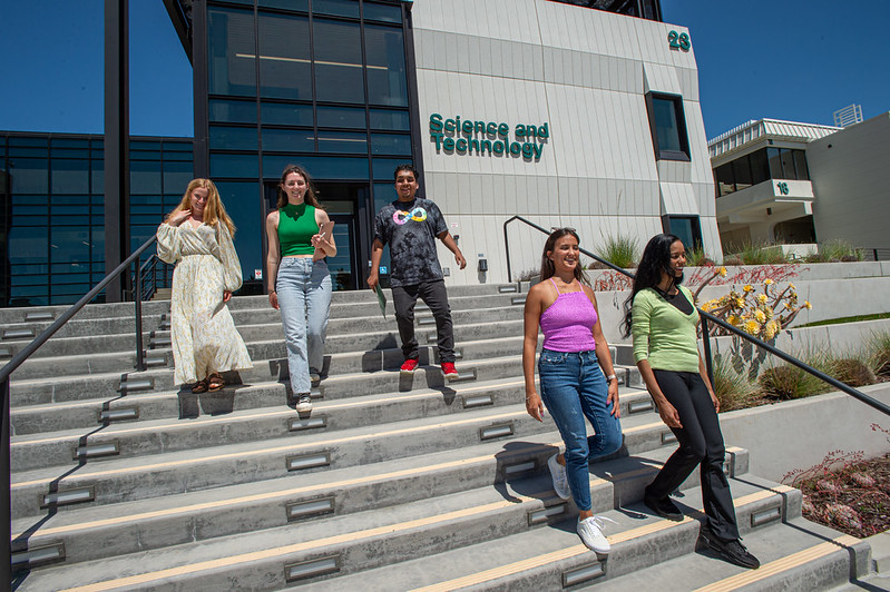 Students walking down the outdoor steps in front of the Science and Technology building